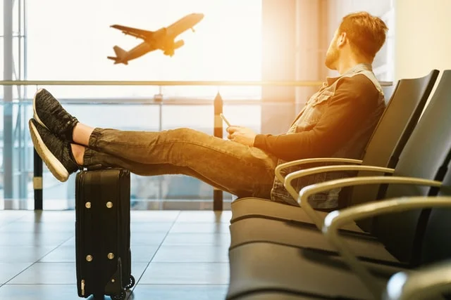 Traveler at airport with suitcase